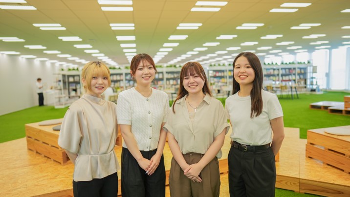 A picture of four women standing side by side&comma; all smiling and looking forward&period; 