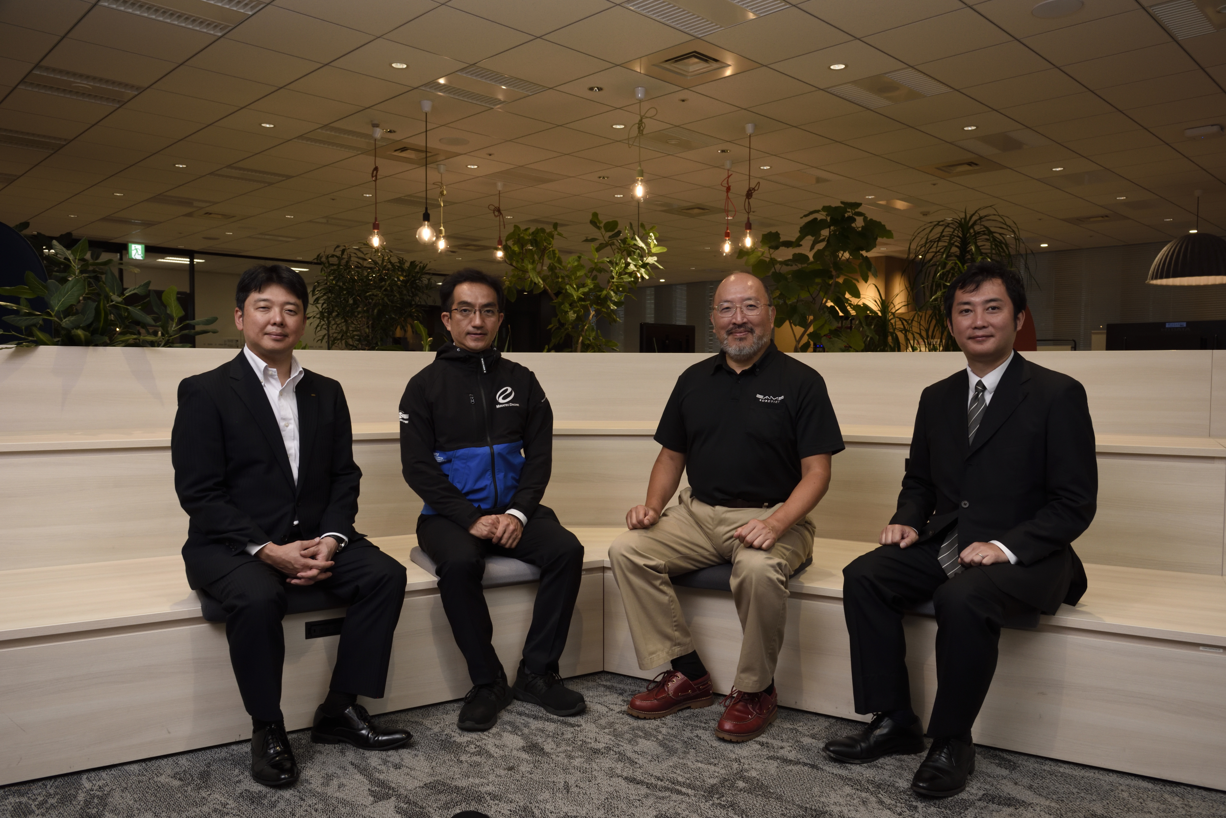 Group photo of interview operators. From left to right: Mr. Tsuchiya SOHGO SECURITY SERVICES CO.,LTD., Mr. Motegi drones of Miratec Co., Ltd., Mr. Sodani of Eames Robotics Co., Ltd., and Mr. Okada of NTT DATA CORPORATION
