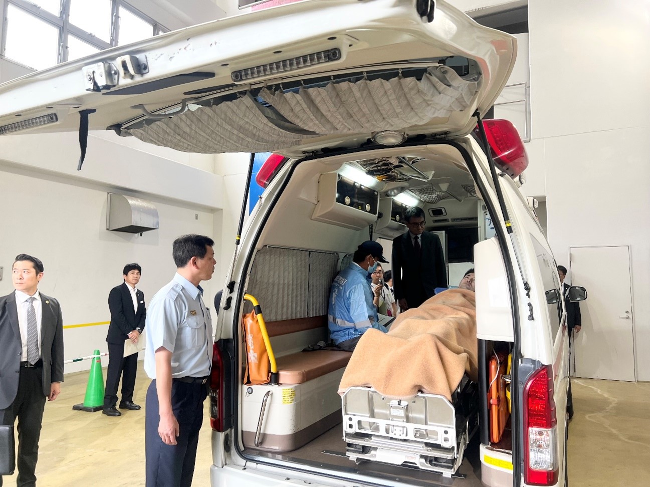 It shows Minister for Digital Transformation Kono inspecting the equipment in ambulances.