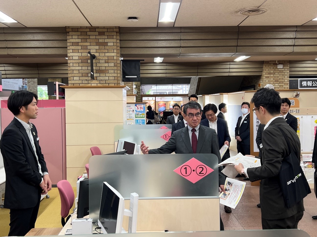 It shows Minister for Digital Transformation Kono checking with the person in charge about the visit by