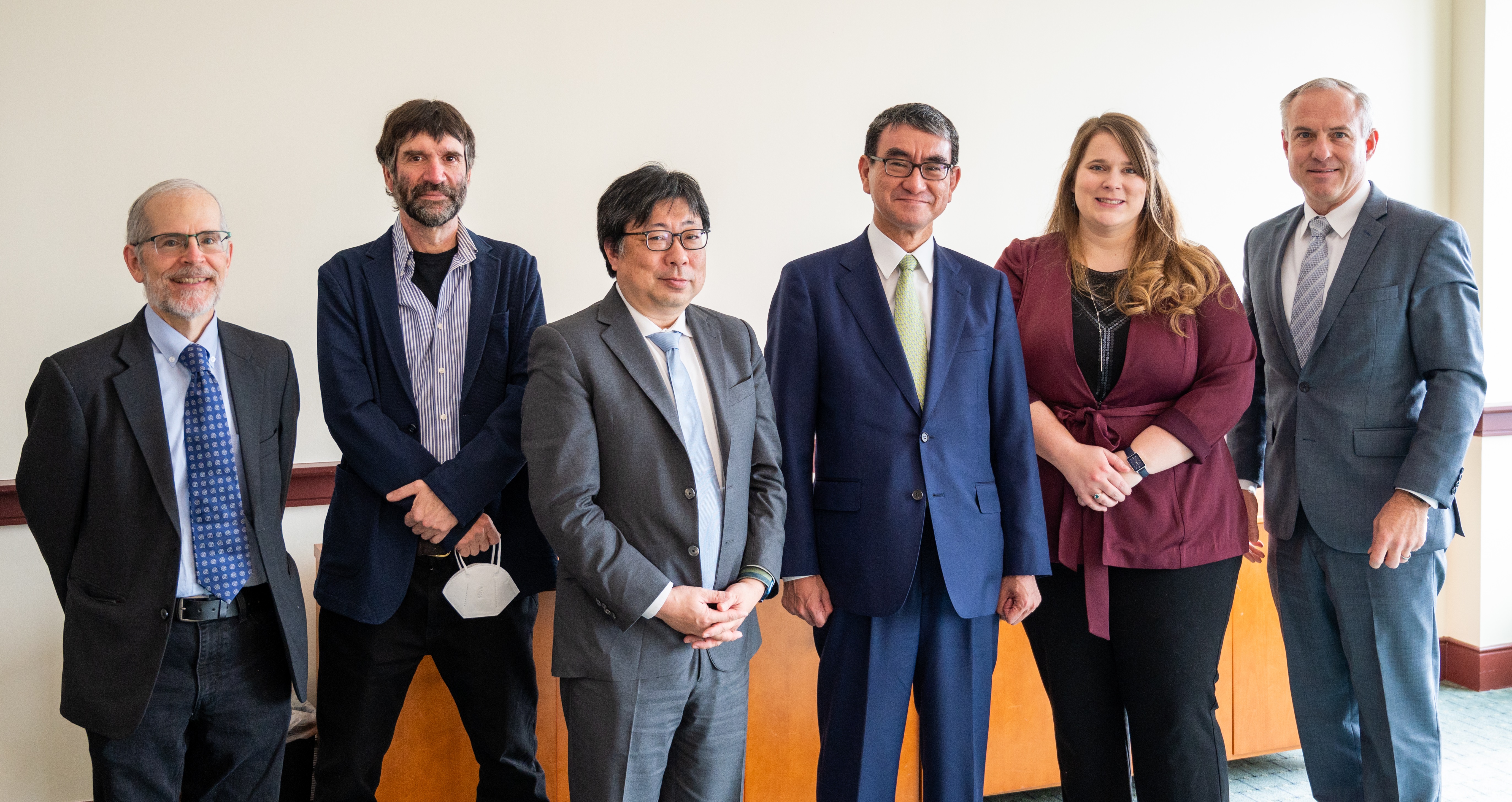 Group photo of Minister Kono (standing center) and professor